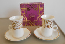 Arabic style coffee (finjan) cups with saucers featuring gold Arabic calligraphy