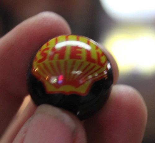 RARE VINTAGE SHELL OIL BLACK GLASS 1" SHOOTER MARBLE DEALER PROMO SIGN GAS OIL