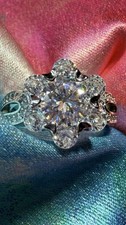New flower-cluster ring featuring a large Moissanite stone scalloped halo