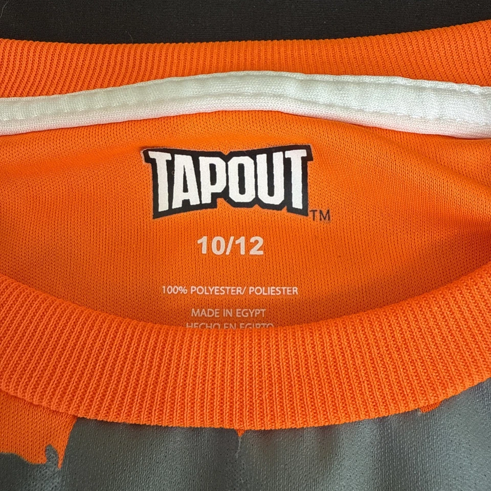 Camisa Tapout Manga Corta Niños Talla 10-12, Naranja/Gris Foto 2 de 4