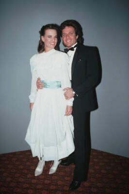 Sherilyn Wolter wearing a full-length white dress a pale blue sash- Old Photo 1