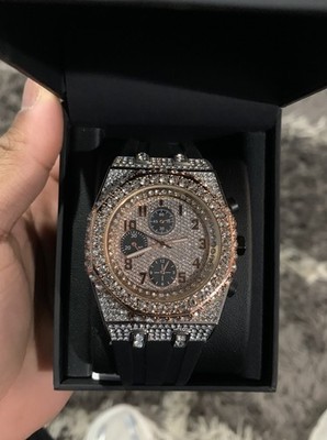 This statement timepiece features a fully iced-out case and bezel.