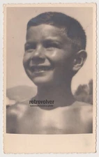 Sun-Kissed Portrait of Young Boy Squinting Into the Warm Summer Light Snapshot