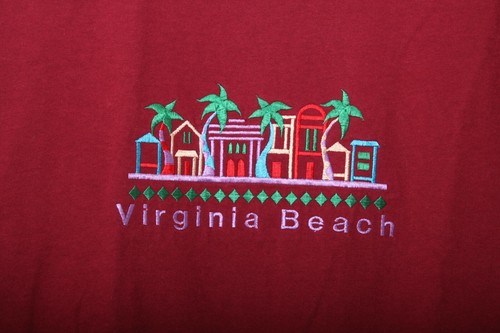 Red vintage 1990s shirt with colorful embroidered Virginia Beach scene, palm trees, buildings, and green diamond accents.
