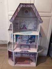pink and purple doll house with furniture and lots of extra dolls & accessories