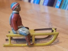 NICE VINTAGE 1910'S G. LEVY  TIN  LITHO BOY ON SLED  PENNY TOY