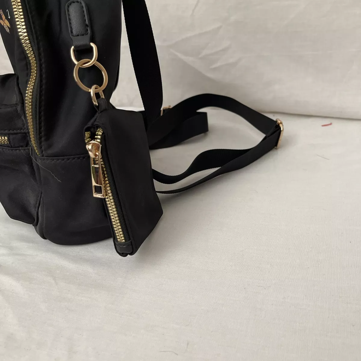 Black backpack top with gold zippers