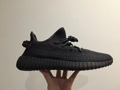 yeezy black static on feet