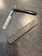 An Oxford brand "Extra Hollow Ground" straight razor with a black handle.