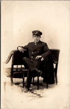 Real Photo Postcard Portrait of Uniformed Military Man Soldier Sitting in Chair