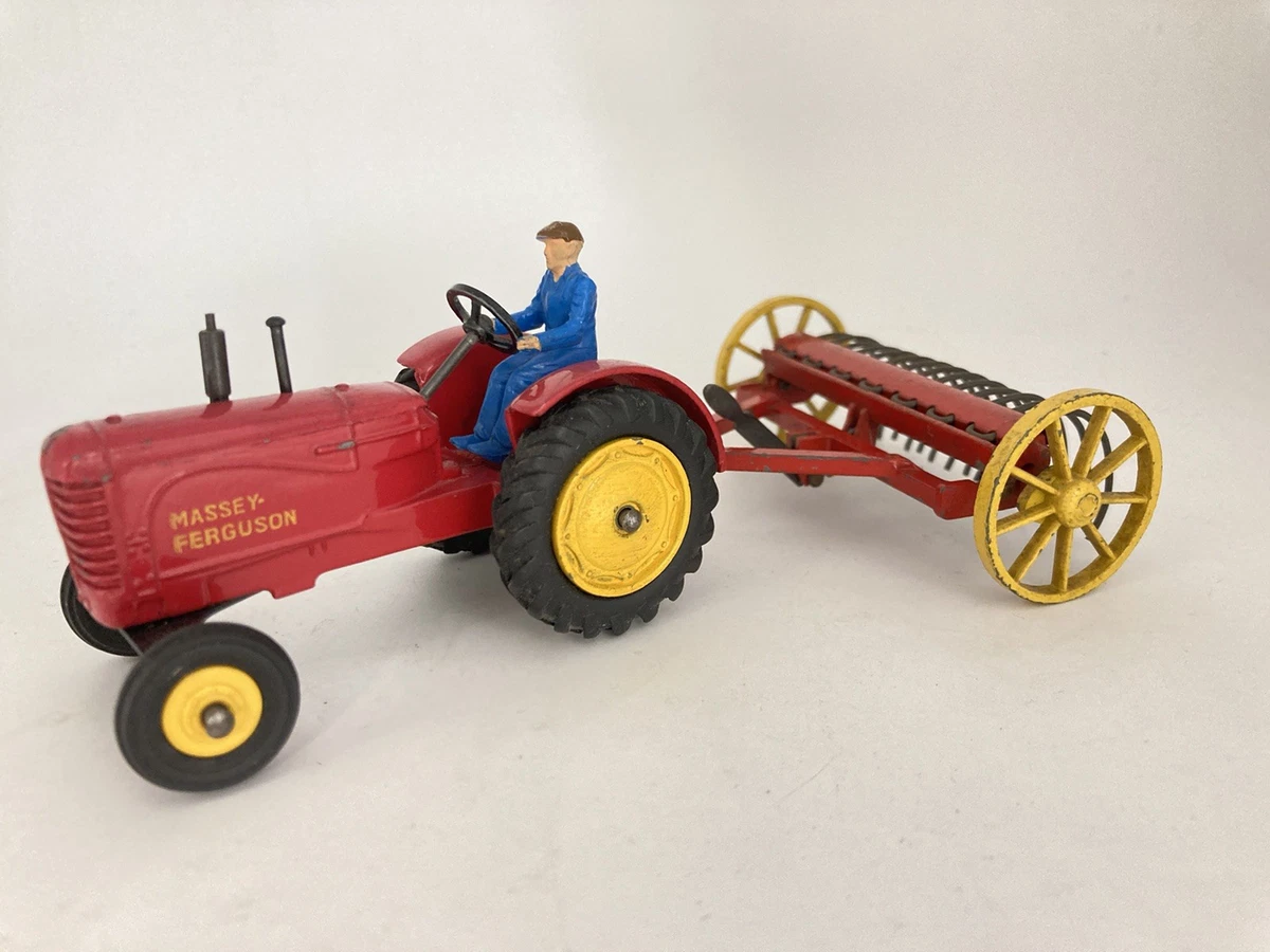 A collection of Dinky Toys tractors, vehicles and farm implements, including two No. 300 Massey Harr
