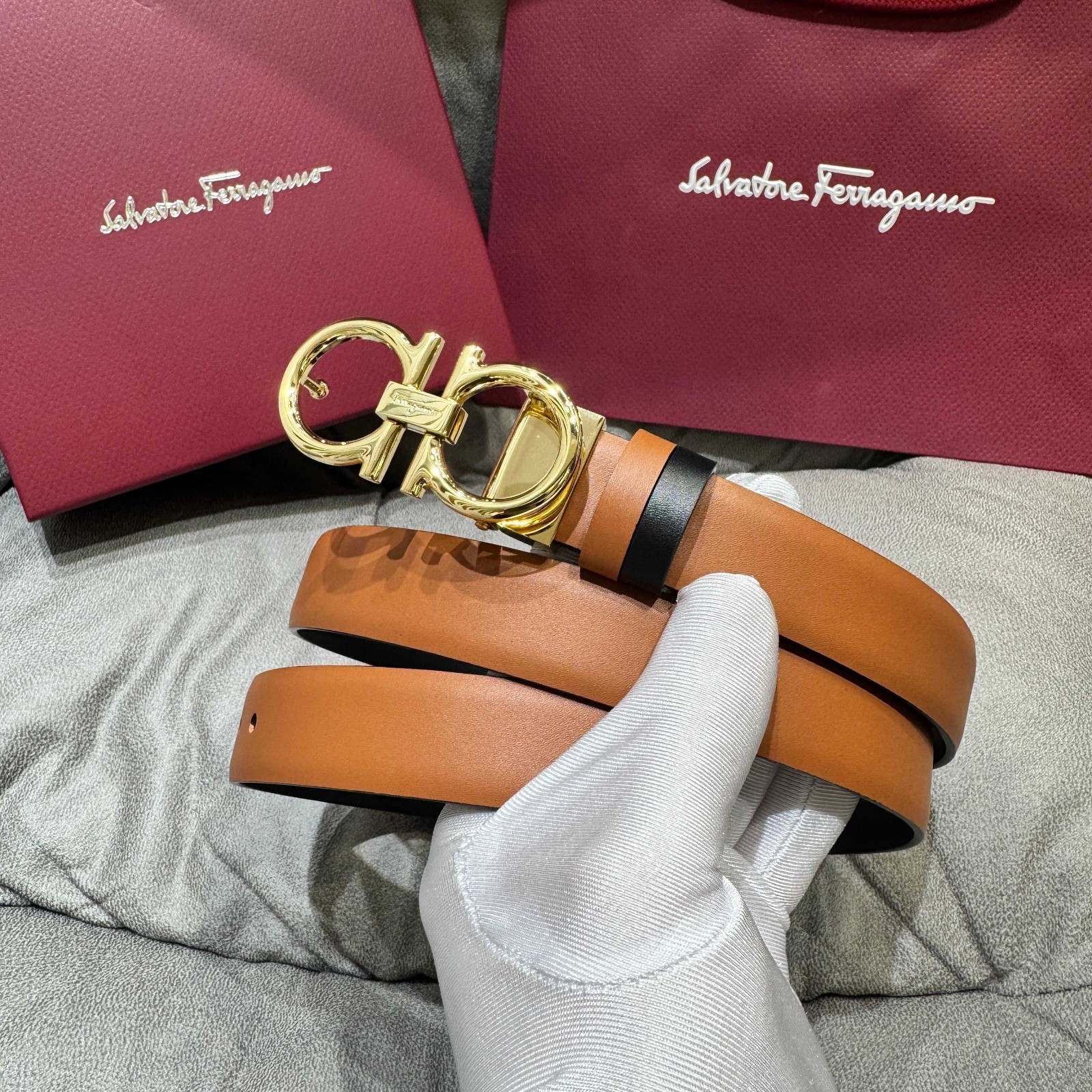 Salvatore Ferragamo reversible leather belt with silver Gancini buckle.