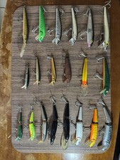 A collection of 20 fishing lures, crankbaits, jerkbaits, and minnow-style plugs