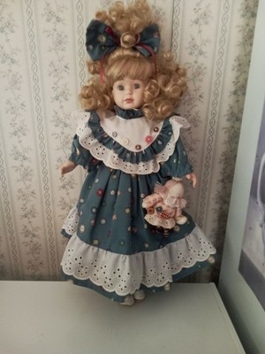 16'' Brass Key Porcelain Doll with a Rag Doll Attached at her Sleeve, Used