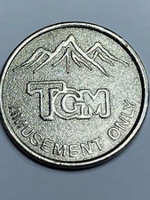 TGM ARCADE TOKEN - VIDEO GAME AMUSEMENT TOKEN - LOOK!