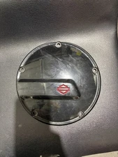 black derby cover with red harley shield