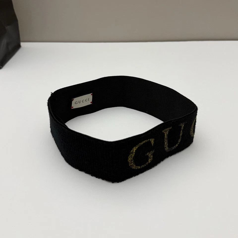 Auténtica diadema Gucci metálica con logotipo de lúrex negra dorada elástica Italia talla única Foto 3 de 4