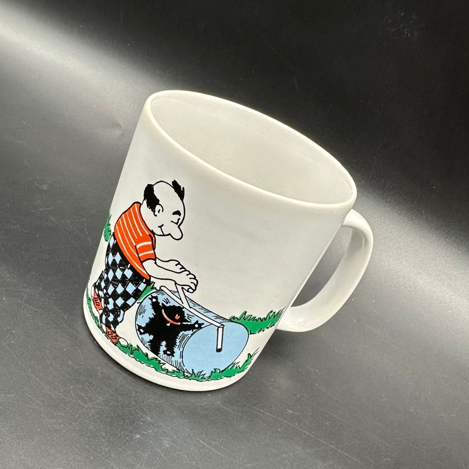 A vintage English kitsch mug featuring a cat mowing the grass — the kind of charmingly bizarre mid-century British humor you can't manufacture today.