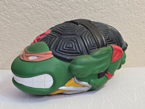 Green 1991 Mirage Studios Teenage Mutant Ninja Turtles Football Raphael with black shell and red headpiece on white background.