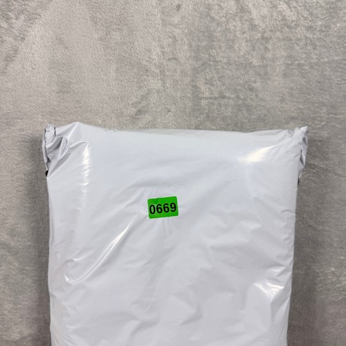 White vintage Russell Athletic Champs XL sweatpants with green zip tie label reading “0669” on front.