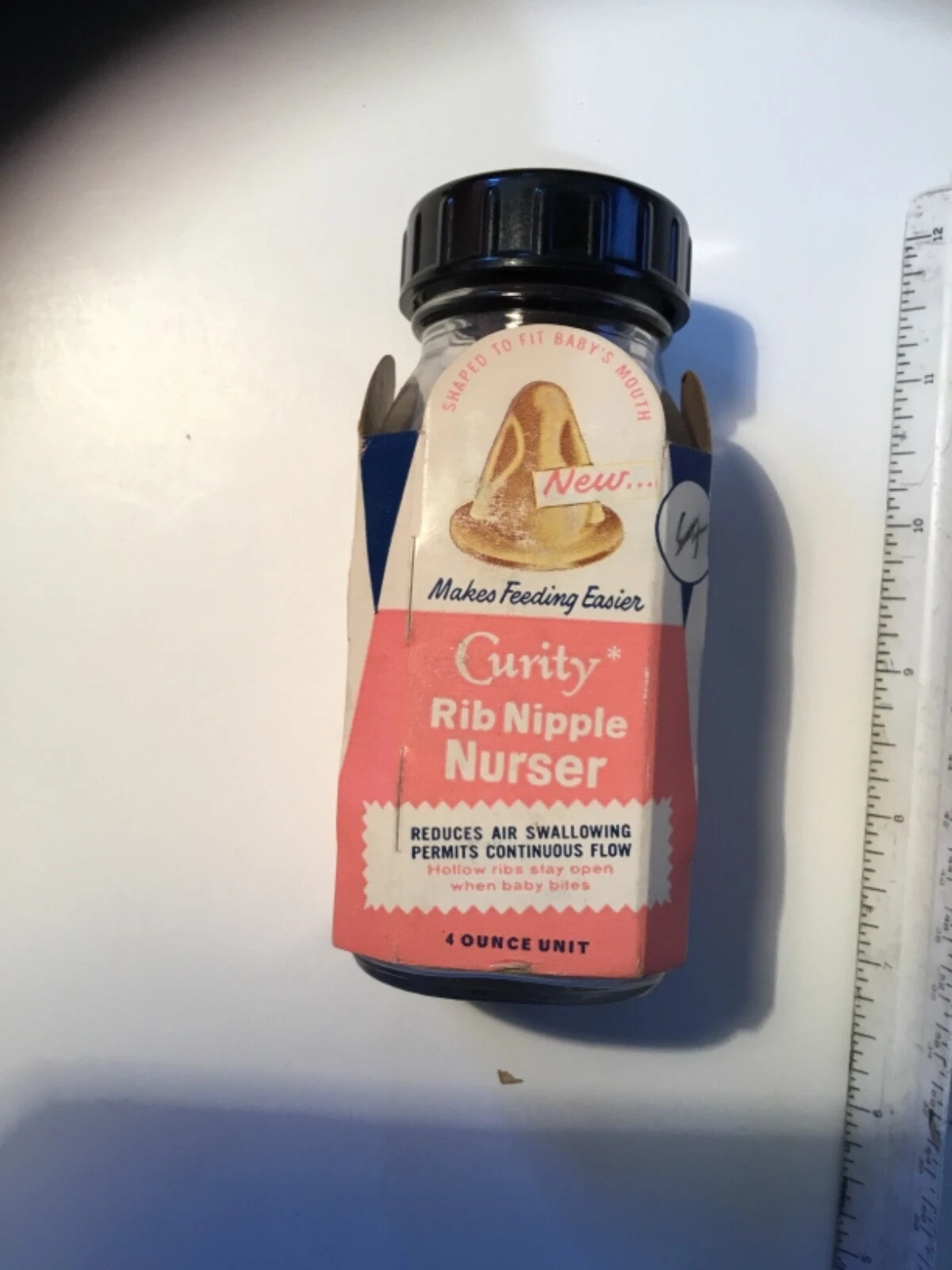 Vintage Curity “Rip Nipple” baby bottle with nipple and bottle sleeve, 4 Oz.