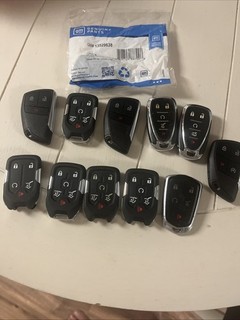 Lot of 12 Cadillac Chevy GMC Buick OEM Key Fobs. 11 Used 1 New In Bag OEM
