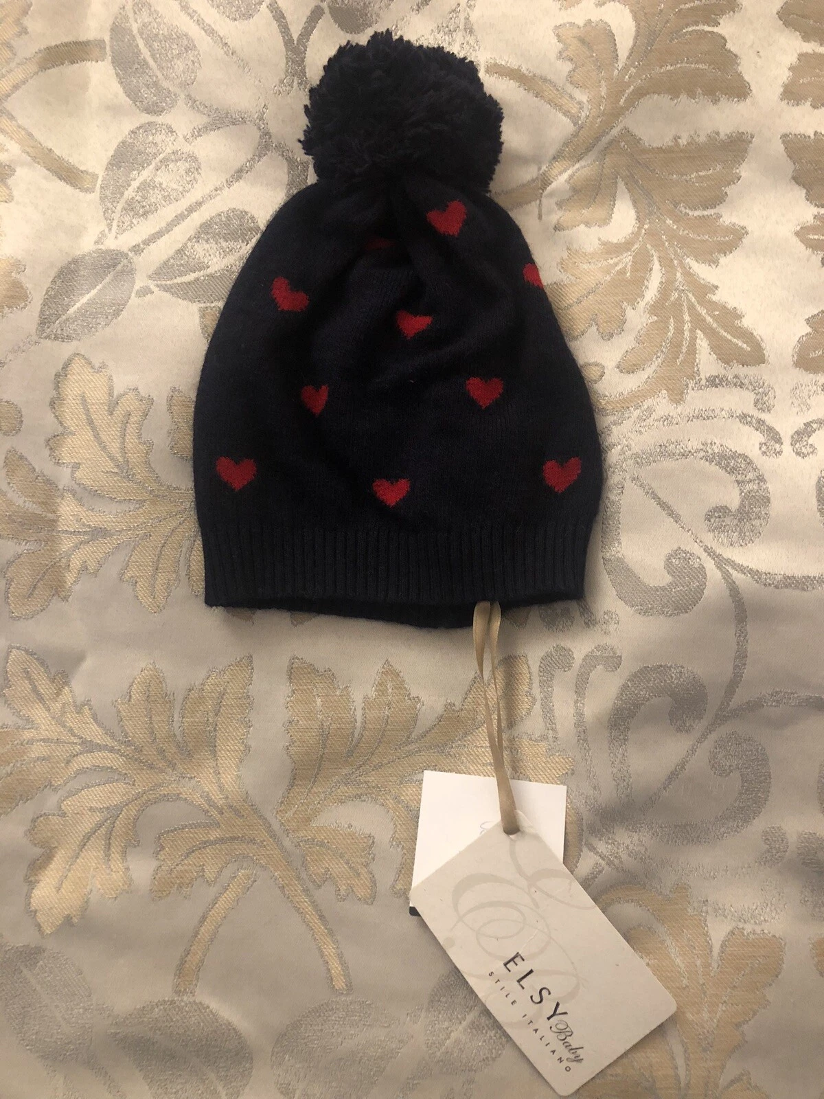 New W Tags. Elsy Baby Hat. Dark Blue W Hearts. Approximate Size 9-12months