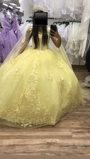 Yellow quince dress with a cape that’s long and the dress has flowers sizable