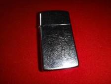 Year 1999 Polished Chrome Zippo Slim Lighter LOVEMAKING Scene Inscribed Logo