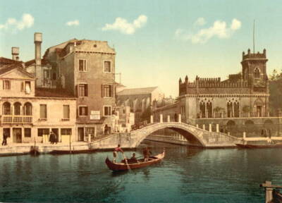 View of a bridge and canal in Venice Italy with an oarsman directi- Old Photo