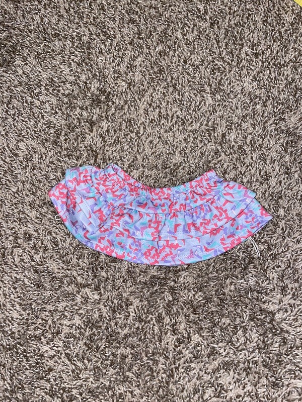 Stuffed animal skirt with hole for tale and ties to hold in place