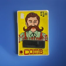 1974 VINTAGE MUSTACHE COMB WITH CASE. HONG KONG. UNPUNCHED CARD. NOVELTY TOY