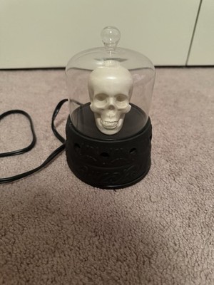 Scentsationals warmer skull housed inside a glass dome for a spooky Halloween