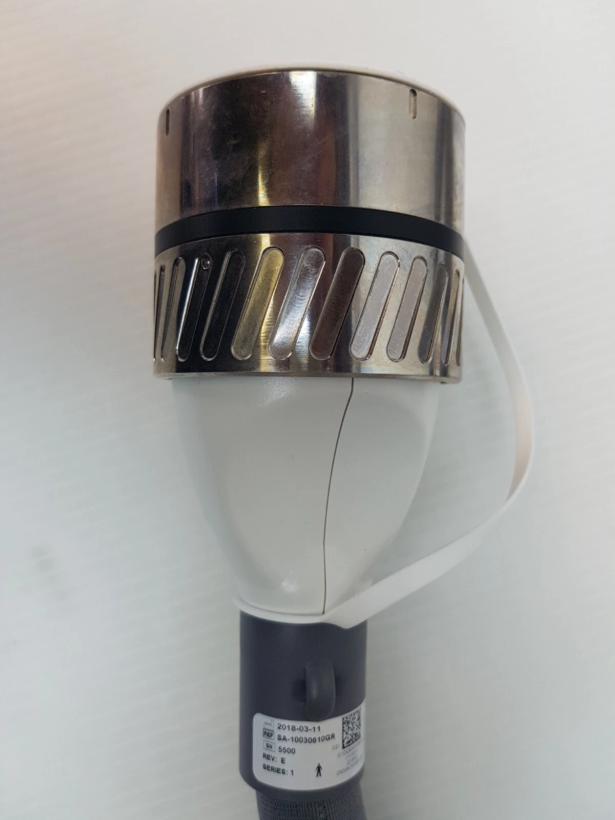 Metal plug-in connector end of the SA-10030610GR handpiece cable with its label