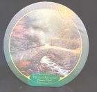 NEW. Thomas Kinkade 24” Round “Bridge of Faith”  750 pc
