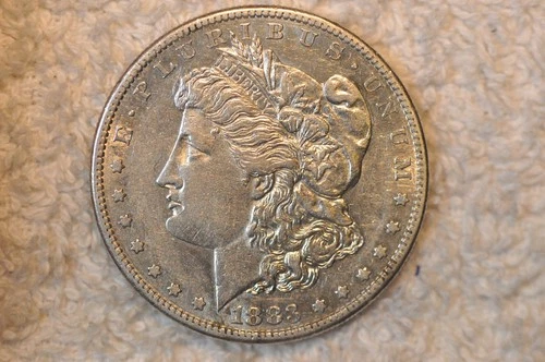 1883-S AU MORGAN DOLLAR