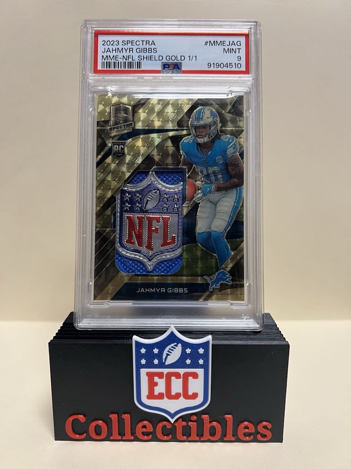 Jahmyr Gibbs Panini Spectra Monumental Memorabilia #MMEJAG NFL Shield Gold 1/1