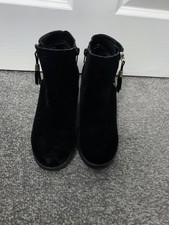 black suede-style ankle boots with zip closures and tassel details, similar