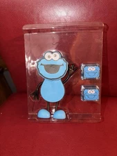 Glo Pals x Sesame Street Cookie Monster Character water-activated bath toy. 