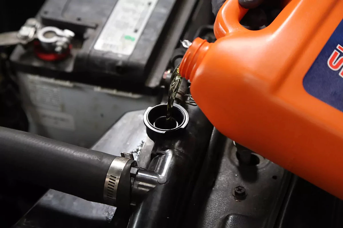 Refilling the radiator with coolant.