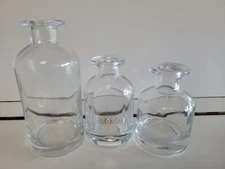 3 CLEAR THICK GLASS DECORATIVE BOTTLES 4 4.25 AND 6 INCHES TALL 1 WITH STARBURST