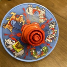 Vintage SMG Metal Spin Toy Top With Animal Cartoon Graphics In Red And Blue.