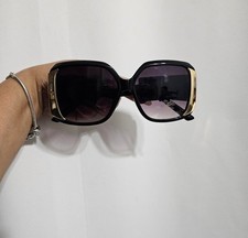 Bob Mackie oversized sunglasses with a black frame and gold accents