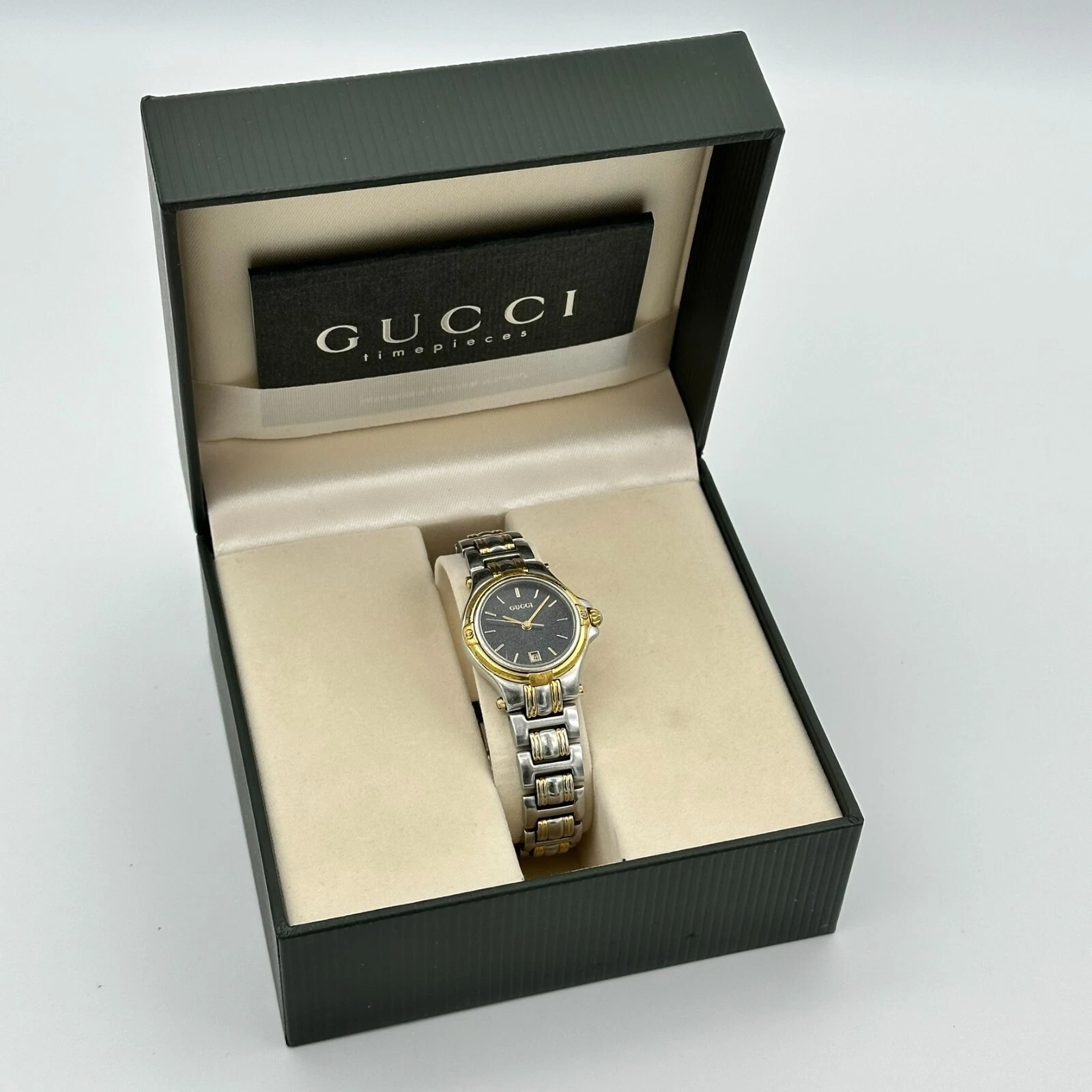 Montre femme vintage GUCCI bicolore tout acier de fabrication suisse cadran noir 9040L avec boîte