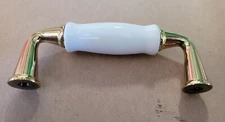 Polished Brass With White Center Drawer Pulls.