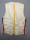 Back zipper of Faconnable vest, medium navy, with red and white diagonal stripes, yellow measuring tape.