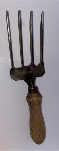 vintage garden hand fork featuring a four-tine metal head and a wooden handle,