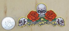 THREE SKULLS WITH ROSES IRON-ON / SEW-ON EMBROIDERED PATCH 3 1/2 " X 2"