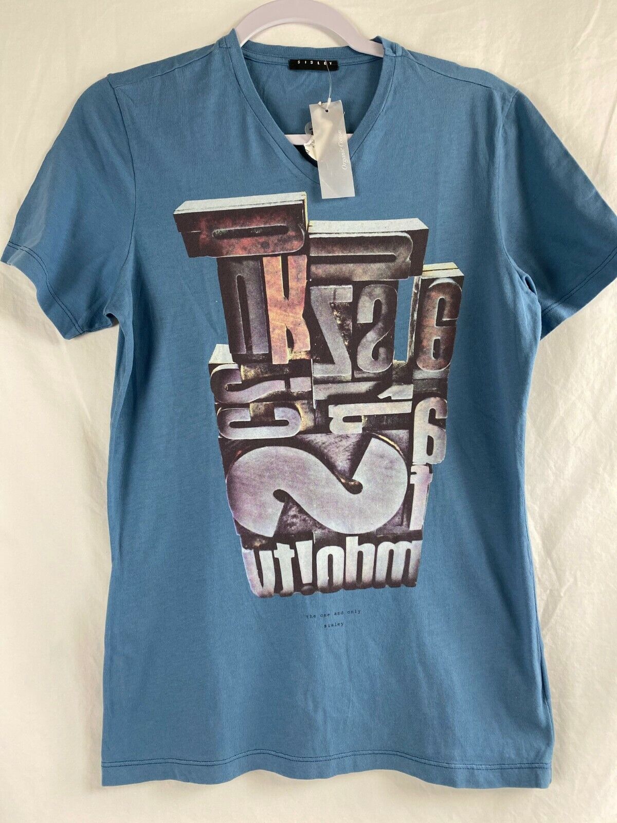 Sisley Blue  V-Neck  Teens T- Shirt, Size S Graphic Print Logo.  B. 31.
