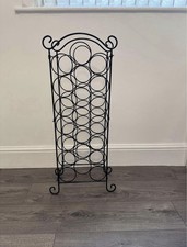 black metal freestanding wine rack that can hold up to 21 bottles